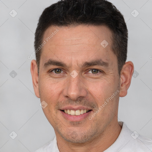 Joyful white adult male with short  brown hair and brown eyes