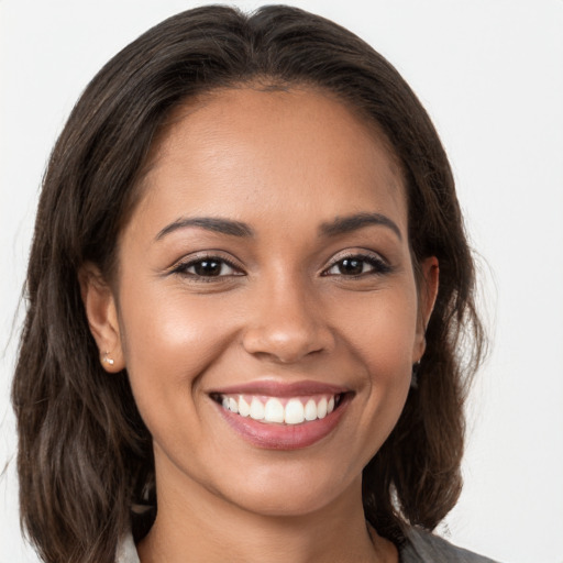 Joyful white young-adult female with long  brown hair and brown eyes