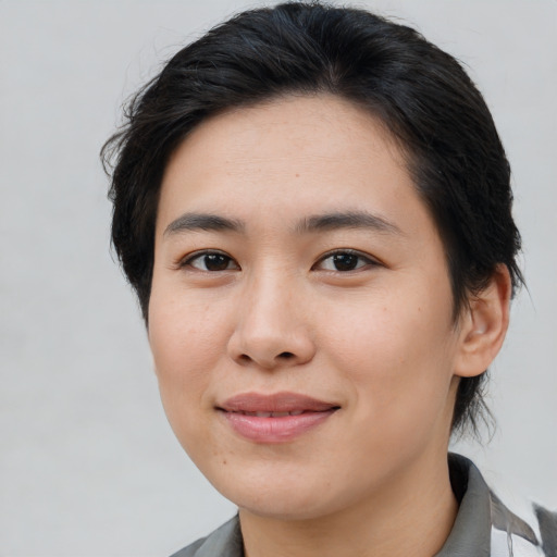 Joyful asian young-adult female with medium  brown hair and brown eyes
