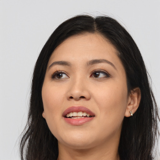Joyful asian young-adult female with long  black hair and brown eyes