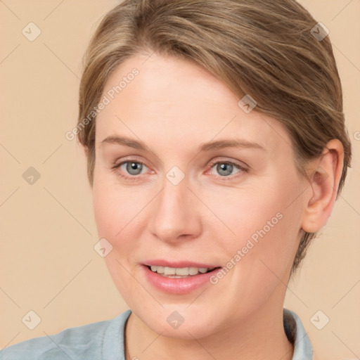 Joyful white young-adult female with medium  brown hair and blue eyes