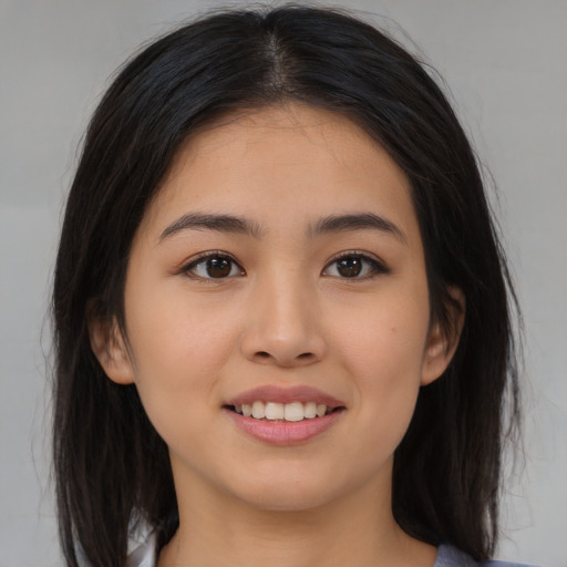 Joyful asian young-adult female with long  brown hair and brown eyes