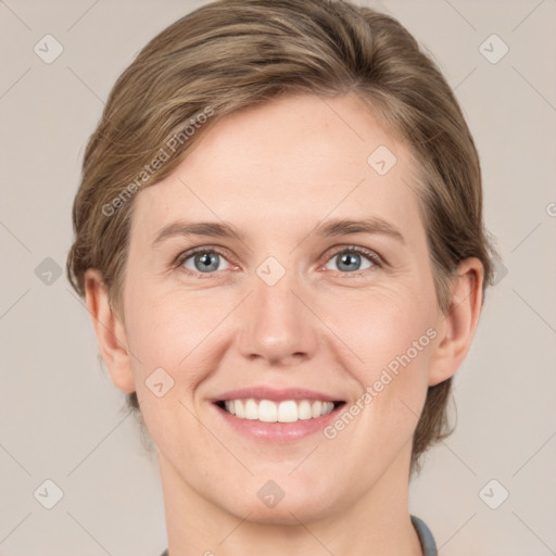 Joyful white young-adult female with medium  brown hair and grey eyes