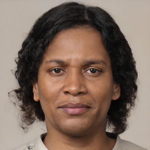 Joyful black young-adult male with medium  brown hair and brown eyes