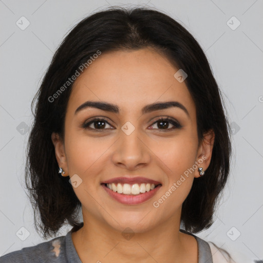 Joyful latino young-adult female with medium  brown hair and brown eyes