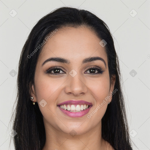 Joyful latino young-adult female with long  brown hair and brown eyes