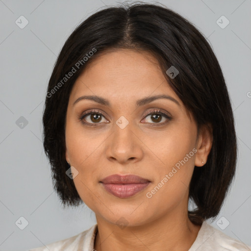 Joyful latino adult female with medium  brown hair and brown eyes