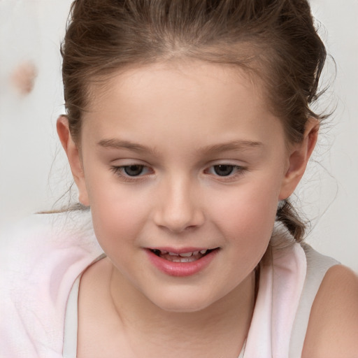 Joyful white child female with medium  brown hair and brown eyes