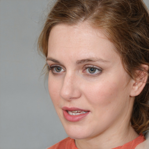Joyful white young-adult female with medium  brown hair and blue eyes