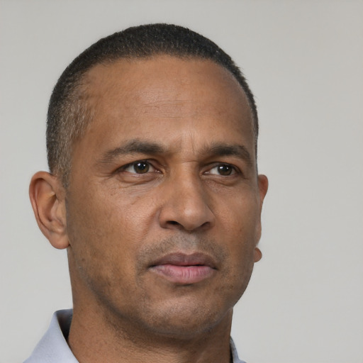 Neutral latino adult male with short  brown hair and brown eyes