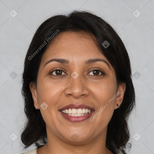 Joyful latino adult female with medium  brown hair and brown eyes