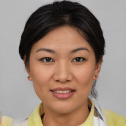 Joyful asian young-adult female with short  brown hair and brown eyes