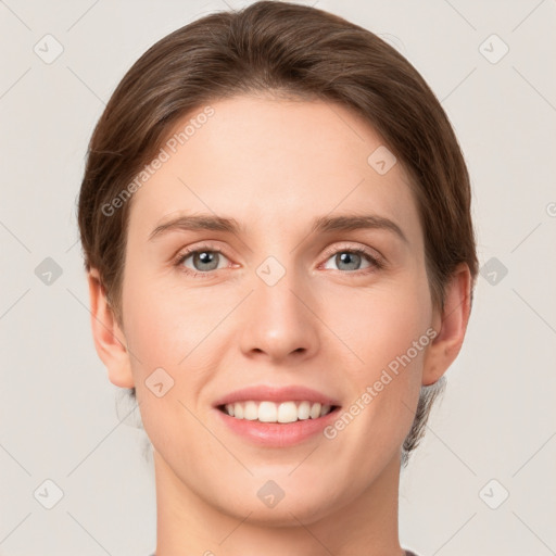 Joyful white young-adult female with short  brown hair and grey eyes