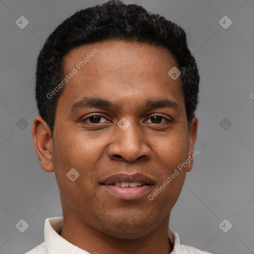 Joyful latino young-adult male with short  brown hair and brown eyes