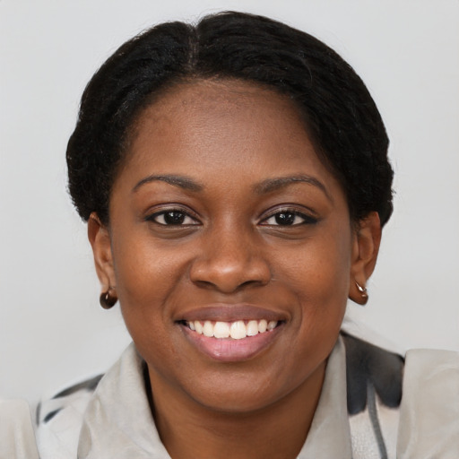 Joyful black young-adult female with medium  brown hair and brown eyes