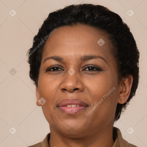 Joyful black adult female with short  brown hair and brown eyes