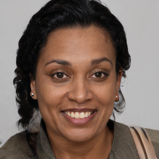 Joyful black adult female with short  brown hair and brown eyes