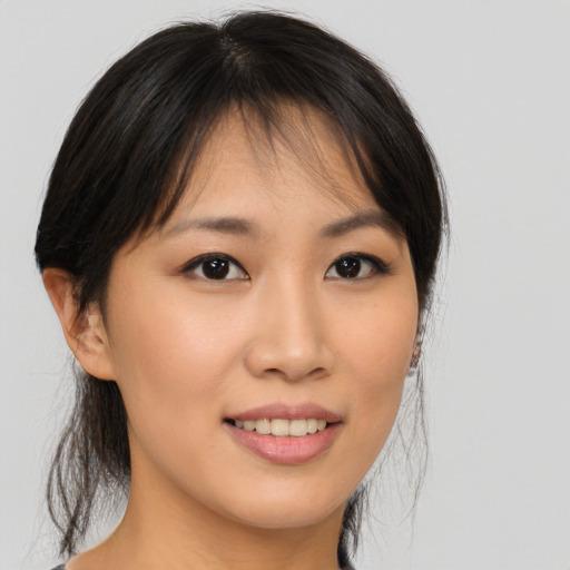 Joyful asian young-adult female with medium  brown hair and brown eyes