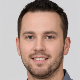 Joyful white young-adult male with short  brown hair and brown eyes