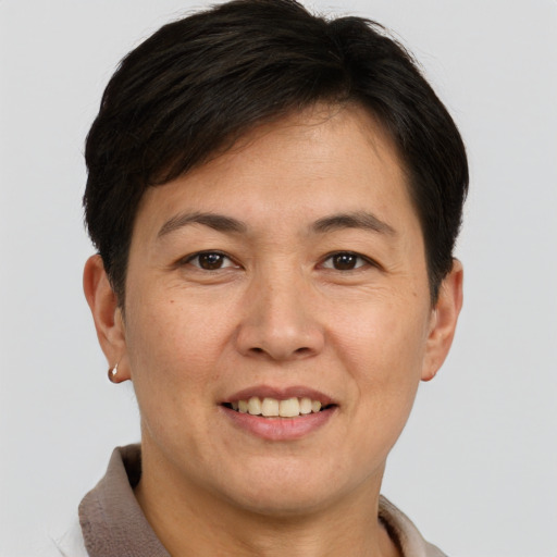 Joyful asian adult female with short  brown hair and brown eyes