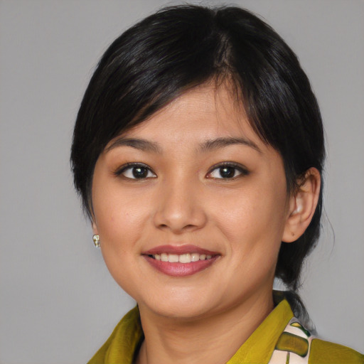 Joyful asian young-adult female with medium  black hair and brown eyes
