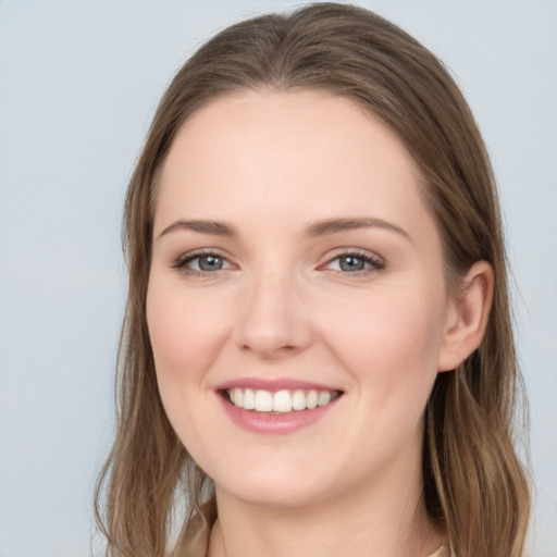 Joyful white young-adult female with long  brown hair and grey eyes