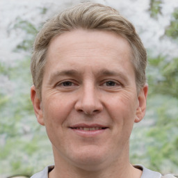 Joyful white adult male with short  brown hair and grey eyes