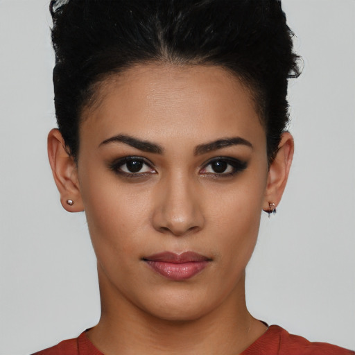 Joyful latino young-adult female with short  brown hair and brown eyes