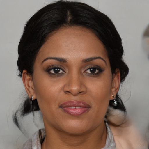 Joyful latino adult female with medium  black hair and brown eyes