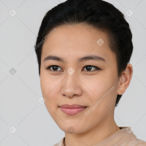 Joyful asian young-adult female with short  black hair and brown eyes