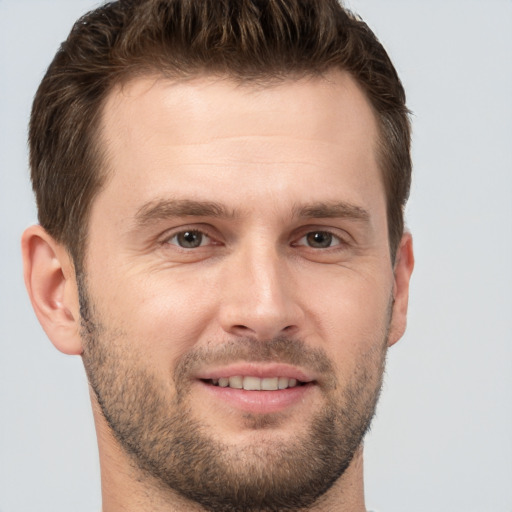 Joyful white adult male with short  brown hair and brown eyes