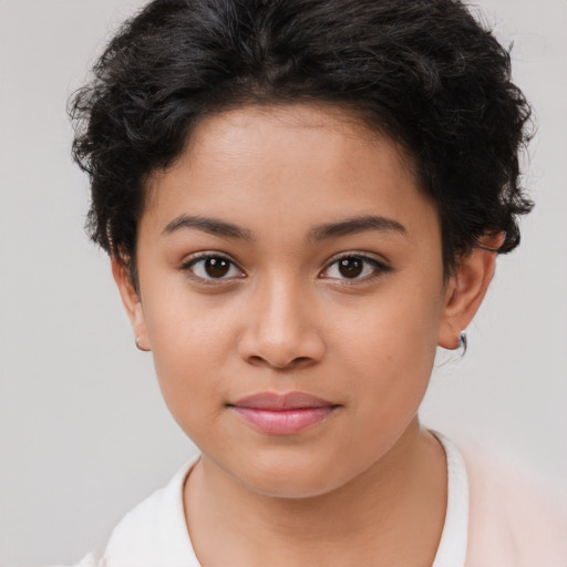 Joyful latino child female with short  brown hair and brown eyes