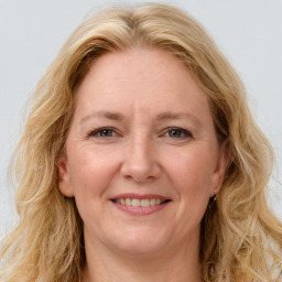 Joyful white adult female with long  brown hair and brown eyes