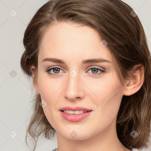 Joyful white young-adult female with medium  brown hair and green eyes