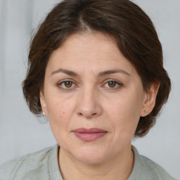 Joyful white adult female with medium  brown hair and brown eyes