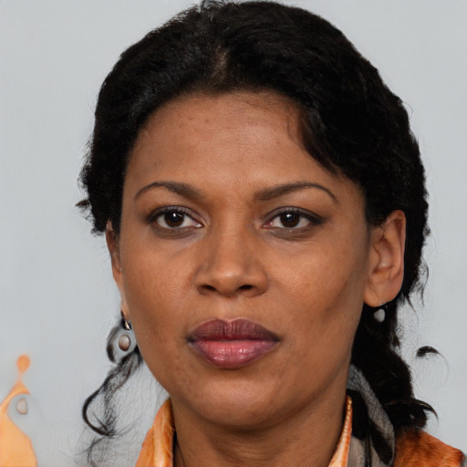 Joyful black adult female with short  brown hair and brown eyes