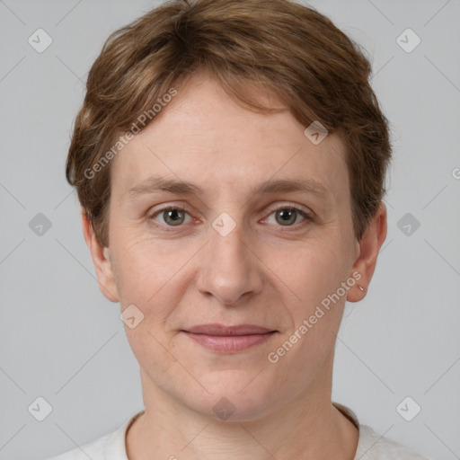 Joyful white young-adult female with short  brown hair and grey eyes