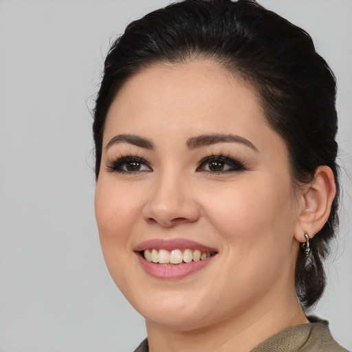 Joyful white young-adult female with medium  black hair and brown eyes