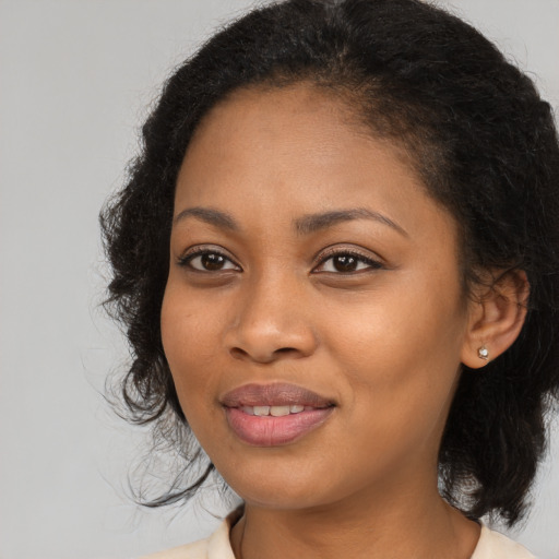 Joyful black young-adult female with medium  black hair and brown eyes