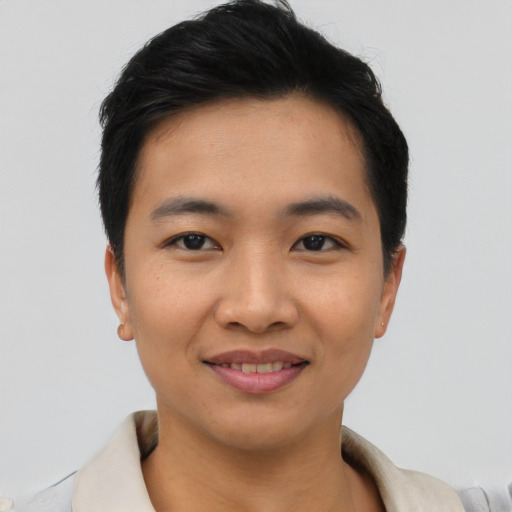 Joyful asian young-adult male with short  black hair and brown eyes