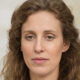 Joyful white young-adult female with long  brown hair and green eyes