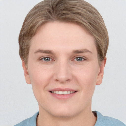 Joyful white young-adult female with short  brown hair and grey eyes