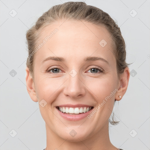 Joyful white young-adult female with short  brown hair and grey eyes