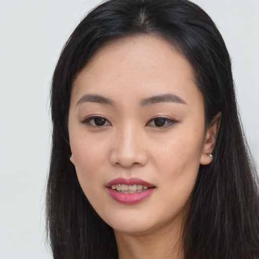 Joyful asian young-adult female with long  black hair and brown eyes