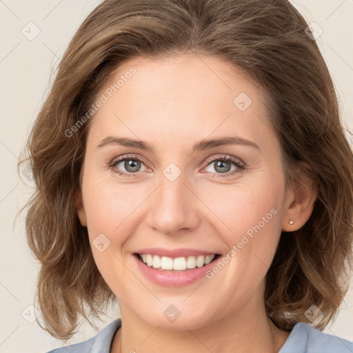 Joyful white young-adult female with medium  brown hair and green eyes