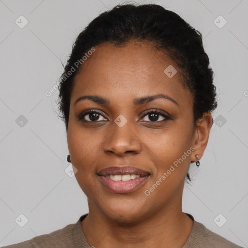 Joyful black young-adult female with short  black hair and brown eyes