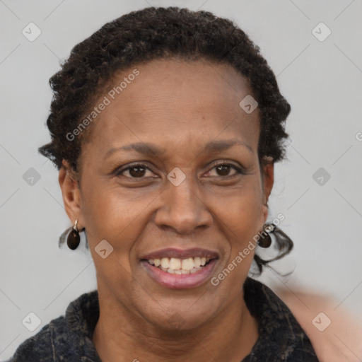 Joyful black adult female with short  brown hair and brown eyes