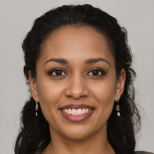 Joyful latino young-adult female with long  brown hair and brown eyes