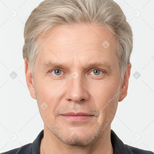 Neutral white adult male with short  blond hair and grey eyes