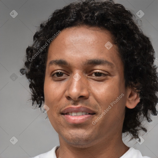 Joyful black young-adult male with short  brown hair and brown eyes